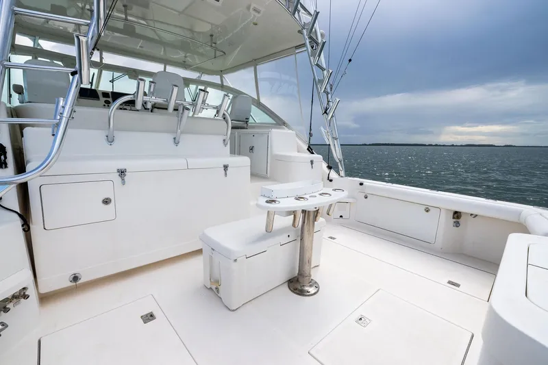 Slide: The Image of 2004 Cabo 40 Hardtop Express boat interior with fishing equipment and ocean view. - 6