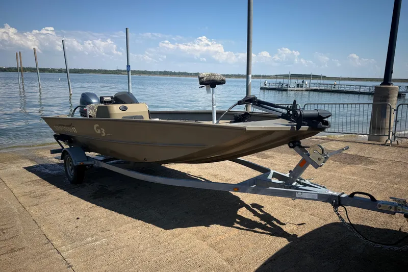 The Image of 2020 G3 Gator Tough 17 SC boat on trailer at lakeside ramp. - 0