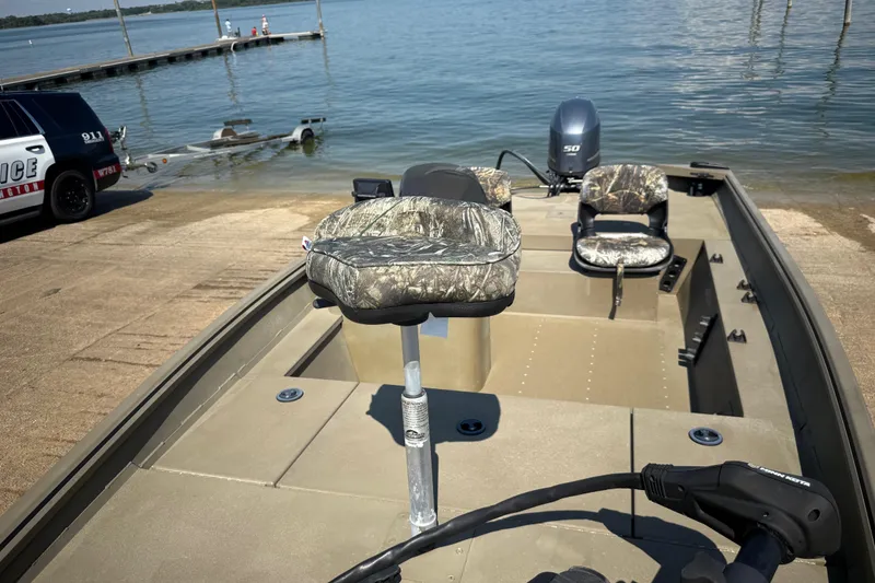Slide: The Image of 2020 G3 Gator Tough 17 SC boat with camo seats by a lake. - 24