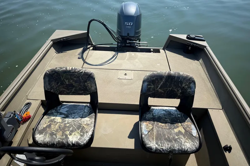 Slide: The Image of 2020 G3 Gator Tough 17 SC boat on calm water, featuring camo seats and steering console. - 30
