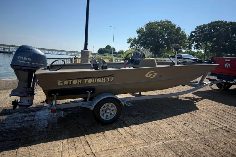 Slide: The Image of 2020 G3 Gator Tough 17 SC boat on trailer by the water. - 5
