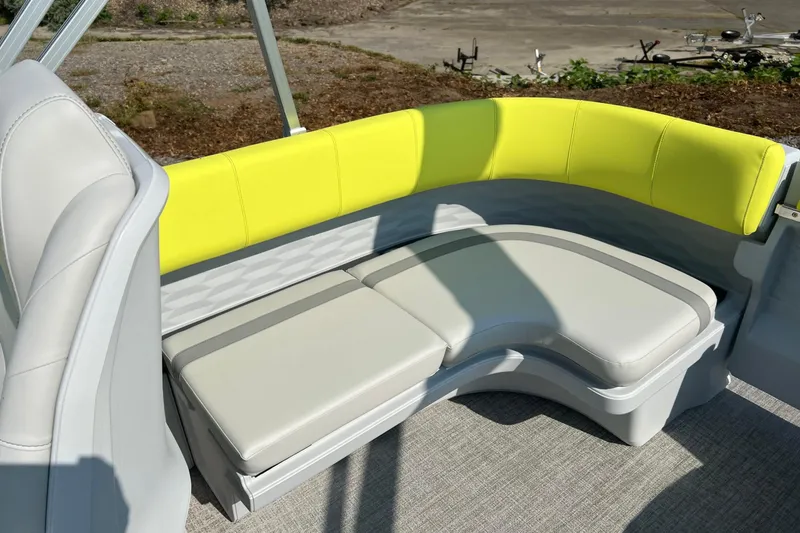 Slide: The Image of 2026 Tahoe Pontoon AURA 1985 boat interior with curved seating and bright yellow accents. - 11