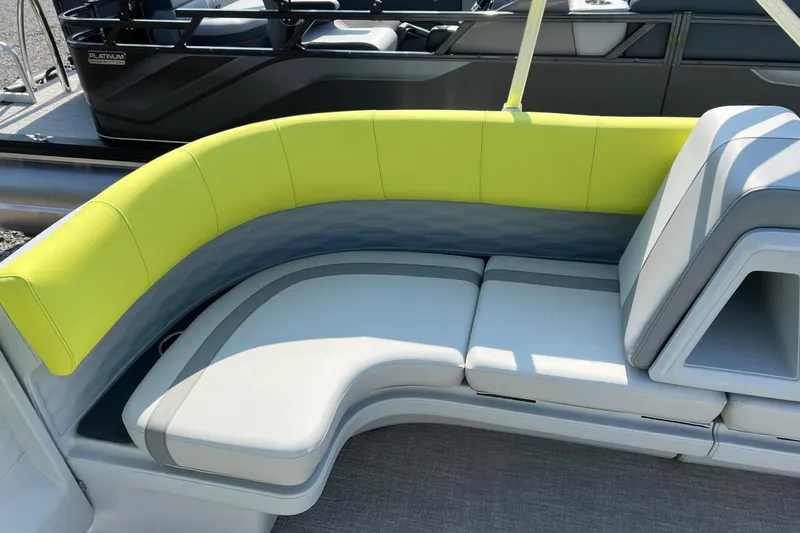 Slide: The Image of 2026 Tahoe Pontoon AURA 1985 with vibrant seating, featuring lime green and gray upholstery. - 12