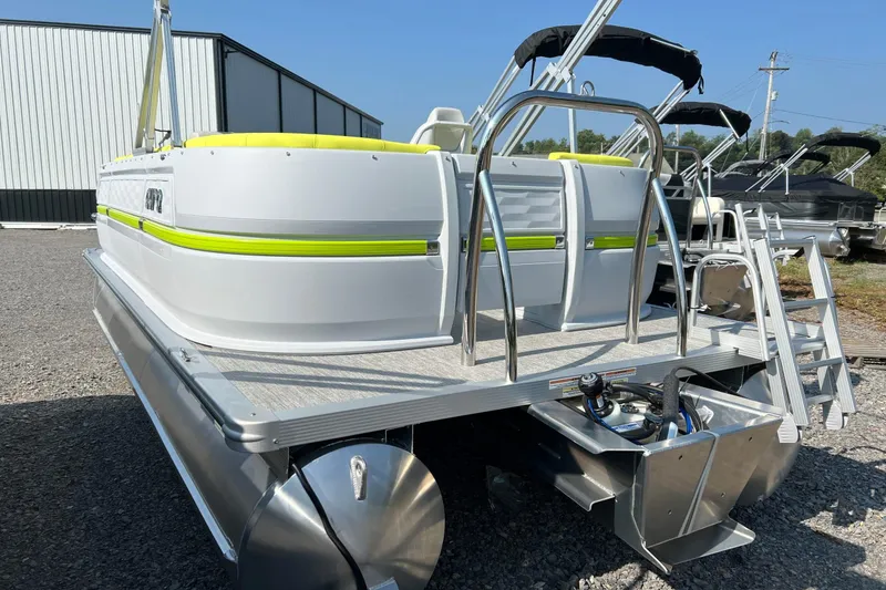 Slide: The Image of 2026 Tahoe Pontoon AURA 1985 with sleek design and vibrant accents, parked outdoors. - 5