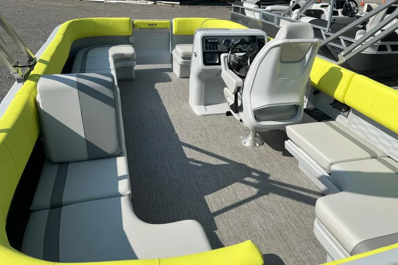 Slide: The Image of 2026 Tahoe Pontoon AURA 1985 interior with yellow and gray seating, modern helm, and spacious layout. - 8