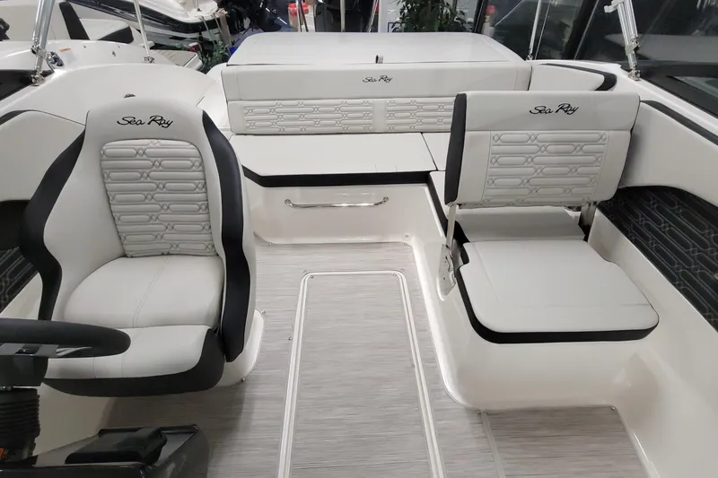 Slide: The Image of 2025 Sea Ray SPX 190 Outboard interior with white seating and modern design. - 3