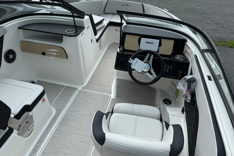 Slide: The Image of 2025 Sea Ray SPX 190 Outboard boat interior with steering wheel and seating. - 4