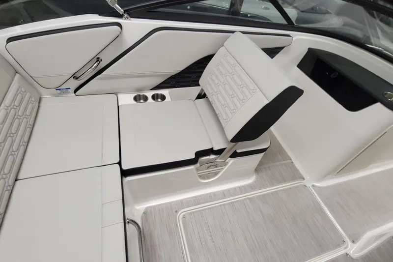 Slide: The Image of 2025 Sea Ray SPX 190 Outboard interior with white seating and cup holders. - 6