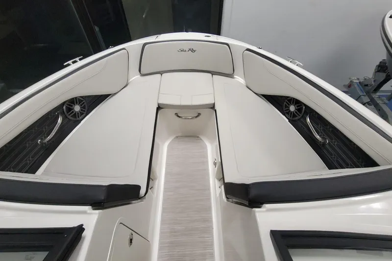 Slide: The Image of 2025 Sea Ray SPX 190 Outboard boat interior with white seating and sleek design. - 7