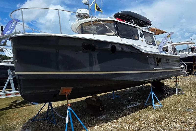 The Image of 2020 Ranger Tugs R27LE boat on stands, displayed outdoors under a blue sky. - 0