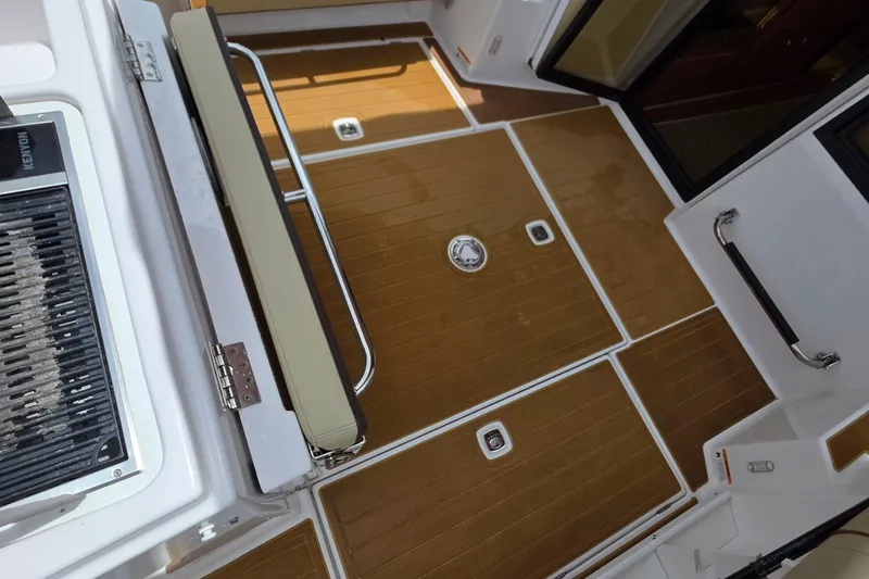 Slide: The Image of 2020 Ranger Tugs R27LE boat with open mini fridge, stocked with drinks. - 10