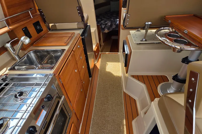 Slide: The Image of Cozy cabin interior of 2020 Ranger Tugs R27LE with nautical-themed bedding. - 18