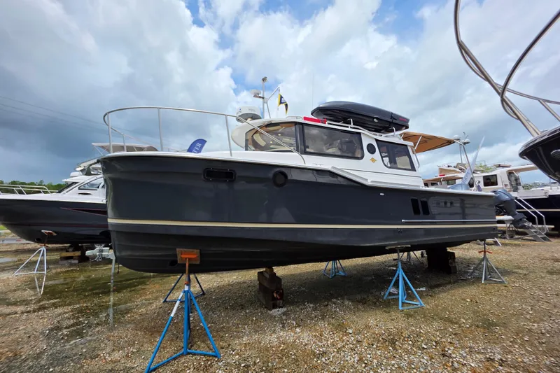 Slide: The Image of 2020 Ranger Tugs R27LE boat interior view with seating and open door. - 6