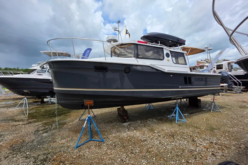 Slide: The Image of 2020 Ranger Tugs R27LE boat deck with teak flooring and stainless steel fittings. - 7