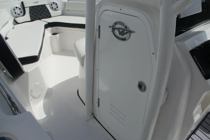Slide: The Image of 2023 Tidewater 210 LXF boat interior with seating and storage compartment. - 10