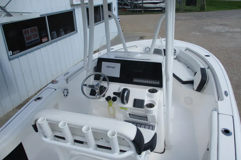 Slide: The Image of 2023 Tidewater 210 LXF boat interior with steering console and seating area. - 17