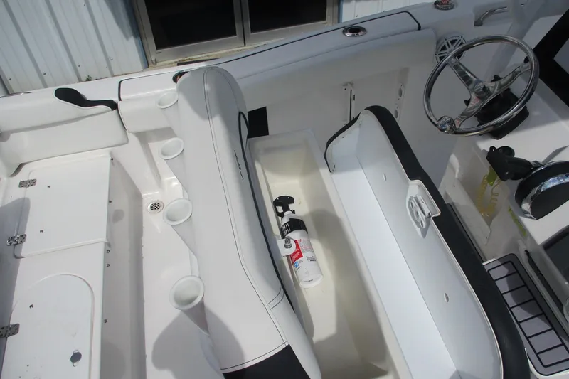 Slide: The Image of 2023 Tidewater 210 LXF boat interior with seating and storage compartments. - 18