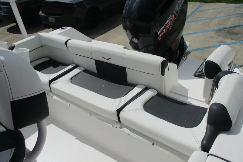 Slide: The Image of 2023 Tidewater 210 LXF boat interior with cushioned seating and Mercury Pro XS engine. - 19