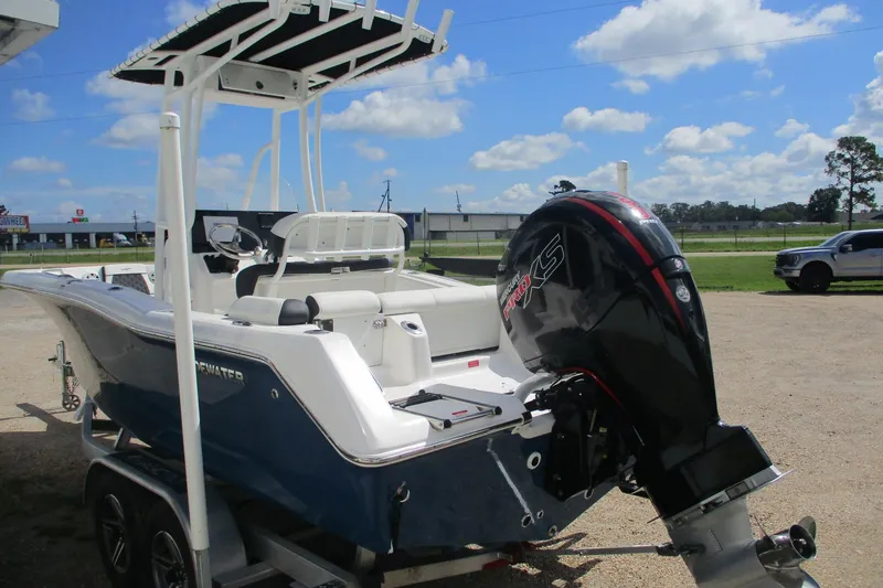 Slide: The Image of 2023 Tidewater 210 LXF boat with powerful outboard motor on a trailer. - 2