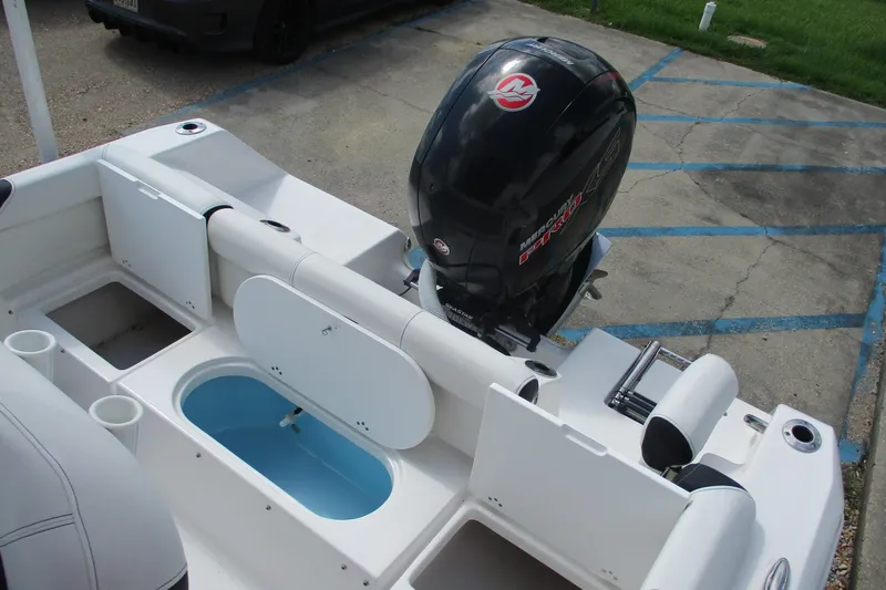 Slide: The Image of 2023 Tidewater 210 LXF boat with Mercury engine, featuring seating and storage compartments. - 20