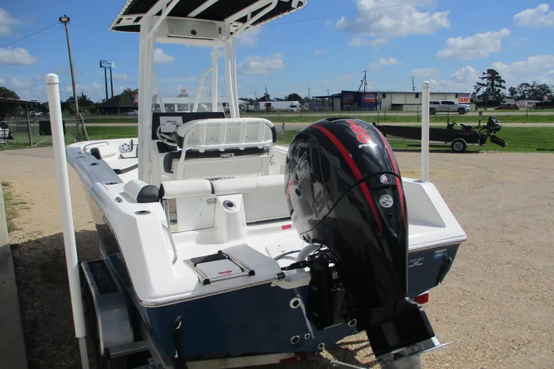 Slide: The Image of 2023 Tidewater 210 LXF boat with powerful outboard motor, parked outdoors. - 4