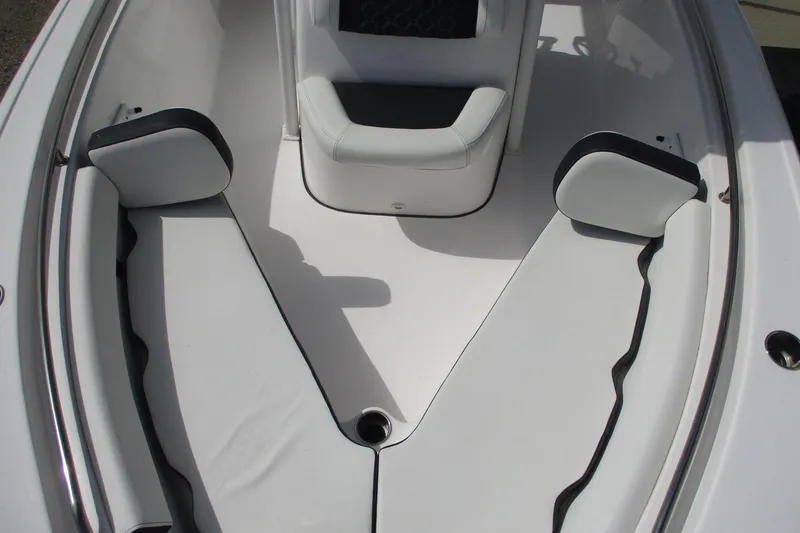 Slide: The Image of 2023 Tidewater 210 LXF boat interior with white cushioned seating and sleek design. - 5