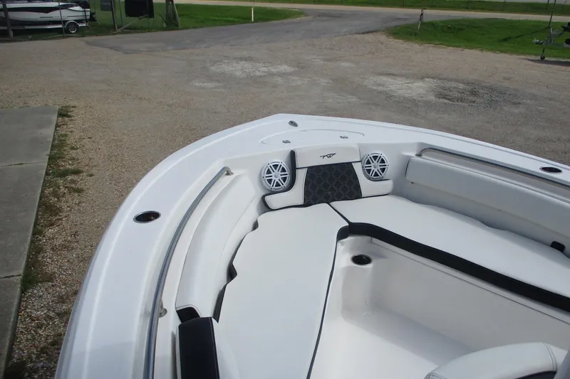 Slide: The Image of 2023 Tidewater 210 LXF boat interior with white seating and speakers. - 9