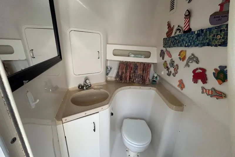 Slide: The Image of Bathroom interior of 1998 Chris-Craft 320 Express Cruiser with nautical decor. - 12