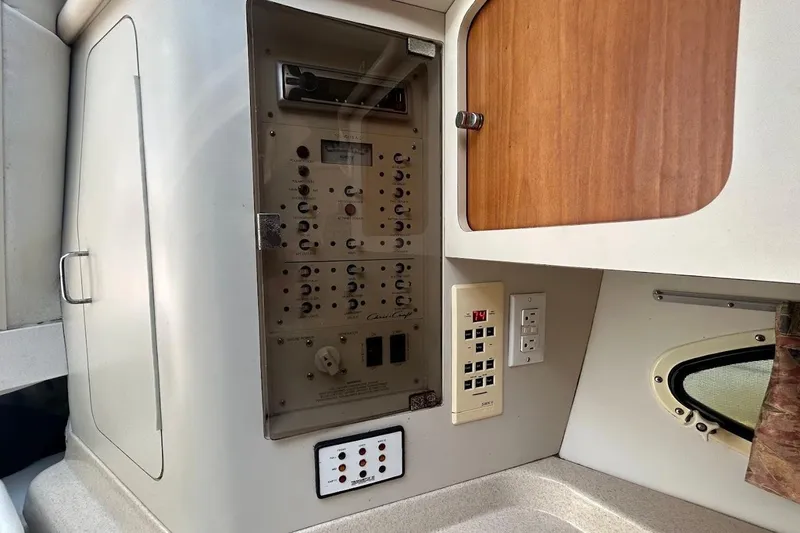 Slide: The Image of 1998 Chris-Craft 320 Express Cruiser interior control panel and cabinetry. - 14