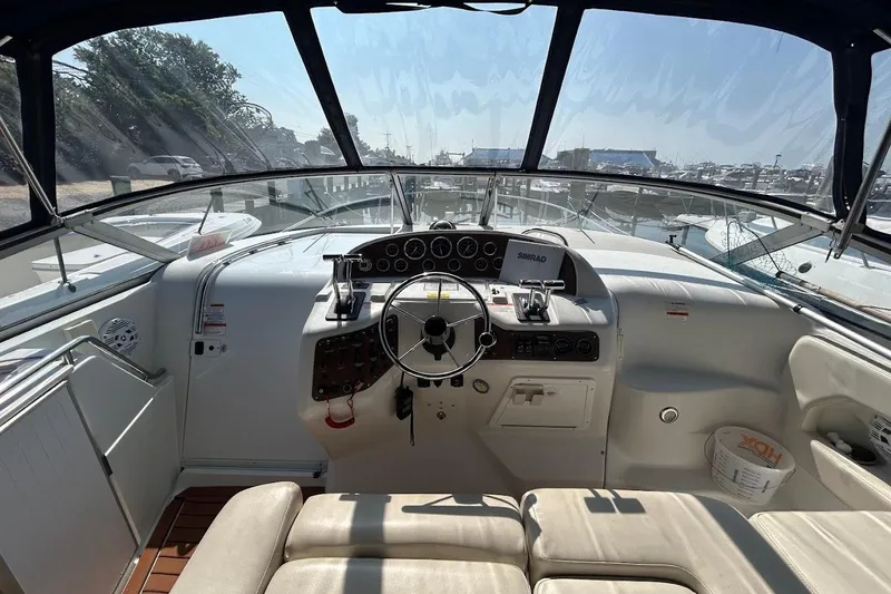 Slide: The Image of 1998 Chris-Craft 320 Express Cruiser cockpit with steering wheel and dashboard controls. - 3