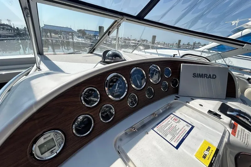Slide: The Image of Dashboard of a 1998 Chris-Craft 320 Express Cruiser with gauges and Simrad navigation. - 5