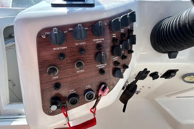 Slide: The Image of Control panel of a 1998 Chris-Craft 320 Express Cruiser boat with various switches. - 6