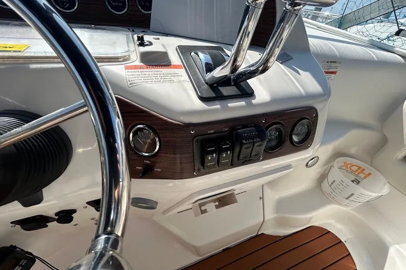 Slide: The Image of 1998 Chris-Craft 320 Express Cruiser helm with steering wheel and control panel. - 7