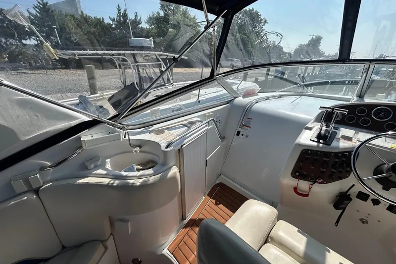 Slide: The Image of 1998 Chris-Craft 320 Express Cruiser cockpit with steering wheel and control panel. - 8