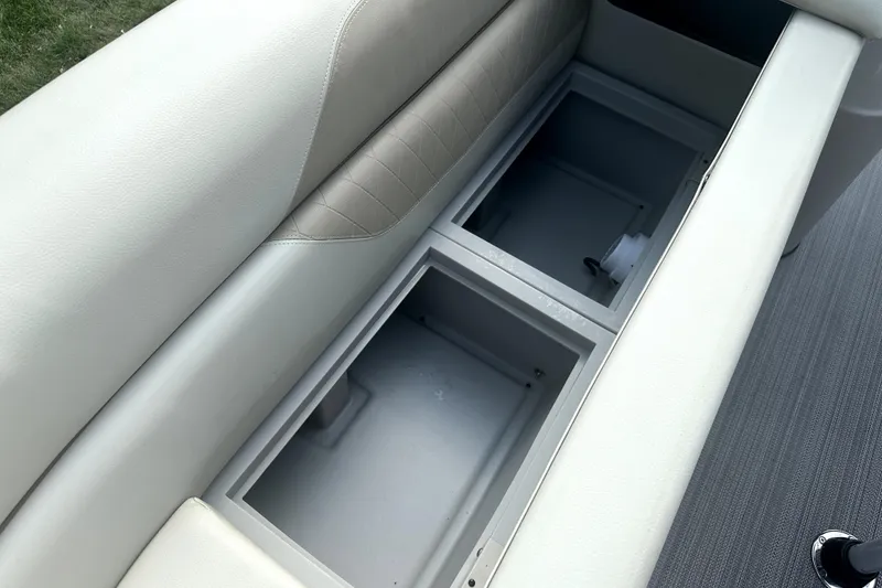 Slide: The Image of 2021 Veranda Vista 22RC boat seat storage compartments, open and empty. - 13