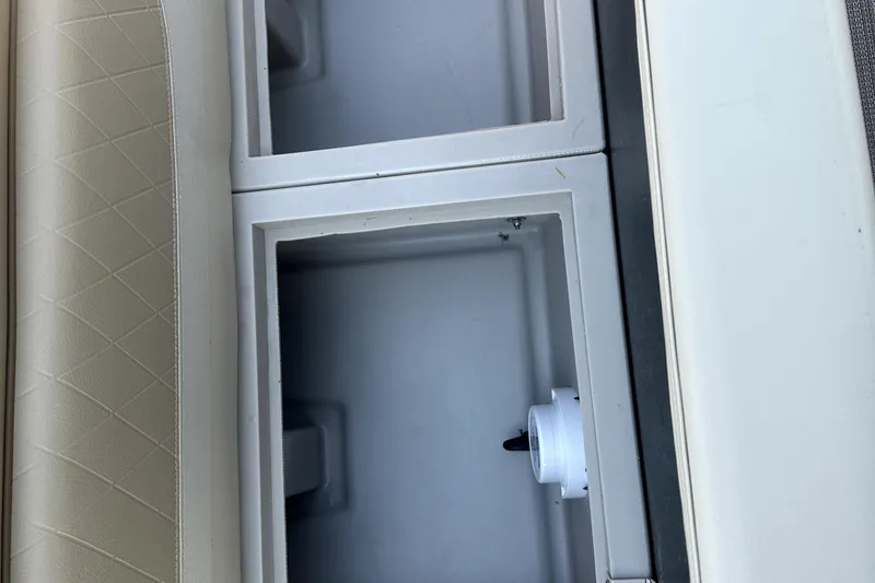 Slide: The Image of 2021 Veranda Vista 22RC storage compartments with beige cushioned seating. - 14