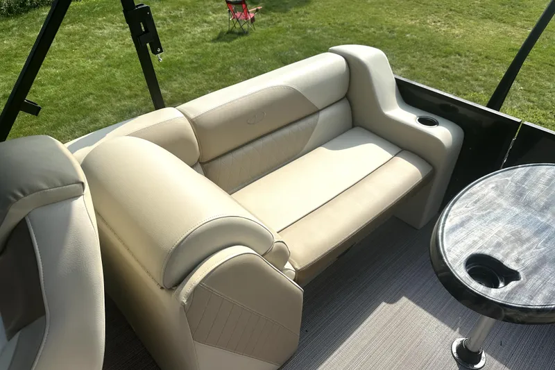 Slide: The Image of Luxurious seating on 2021 Veranda Vista 22RC pontoon boat with beige upholstery and table. - 18