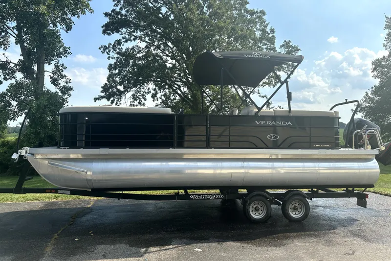 Slide: The Image of 2021 Veranda Vista 22RC pontoon boat on trailer, parked outdoors. - 2