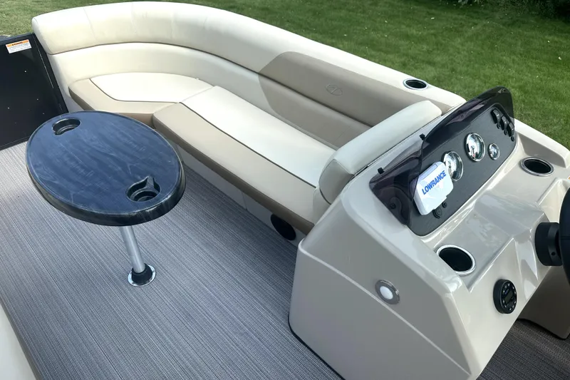 Slide: The Image of 2021 Veranda Vista 22RC boat interior with seating, table, and control panel. - 22
