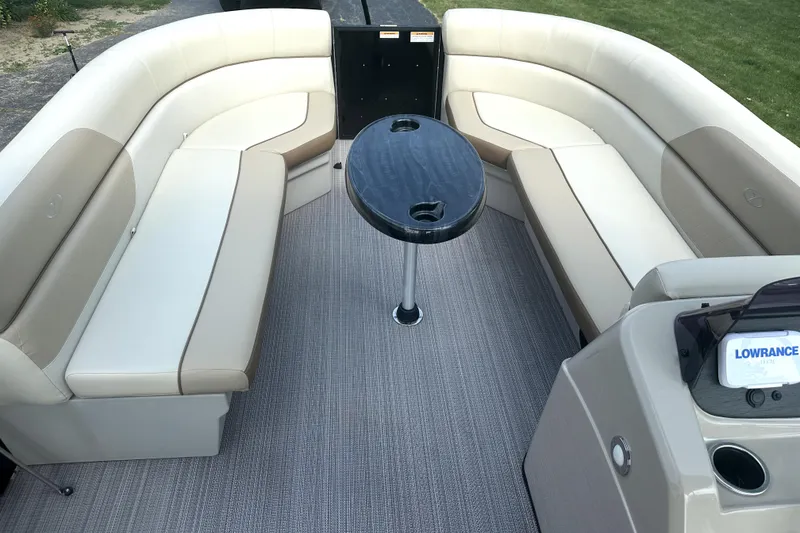 Slide: The Image of 2021 Veranda Vista 22RC boat interior with beige seating and central table. - 25