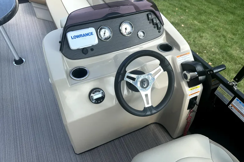 Slide: The Image of 2021 Veranda Vista 22RC boat dashboard with steering wheel and Lowrance display. - 29