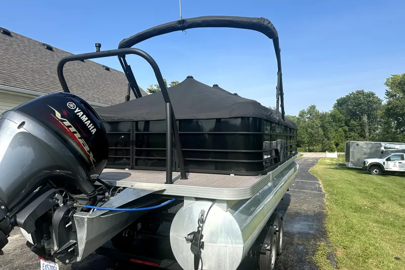 Slide: The Image of 2021 Veranda Vista 22RC pontoon boat with Yamaha engine, parked on driveway. - 3