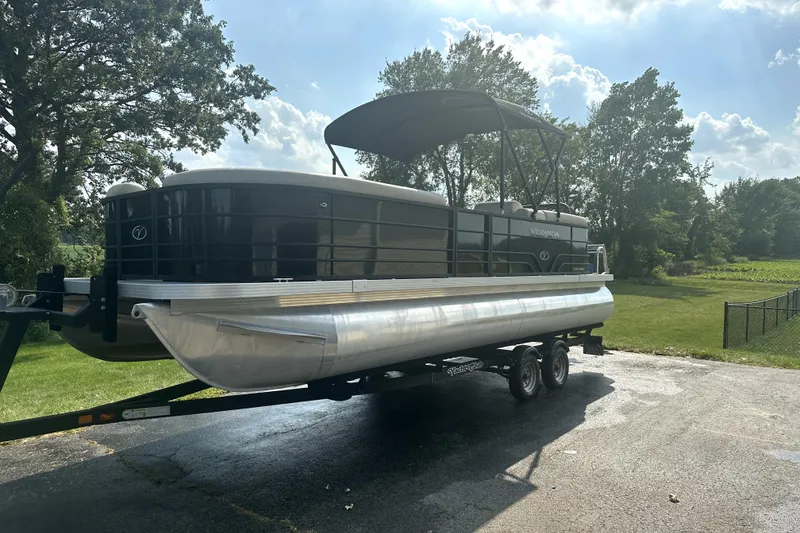 Slide: The Image of 2021 Veranda Vista 22RC pontoon boat on trailer, parked outdoors under sunny sky. - 6