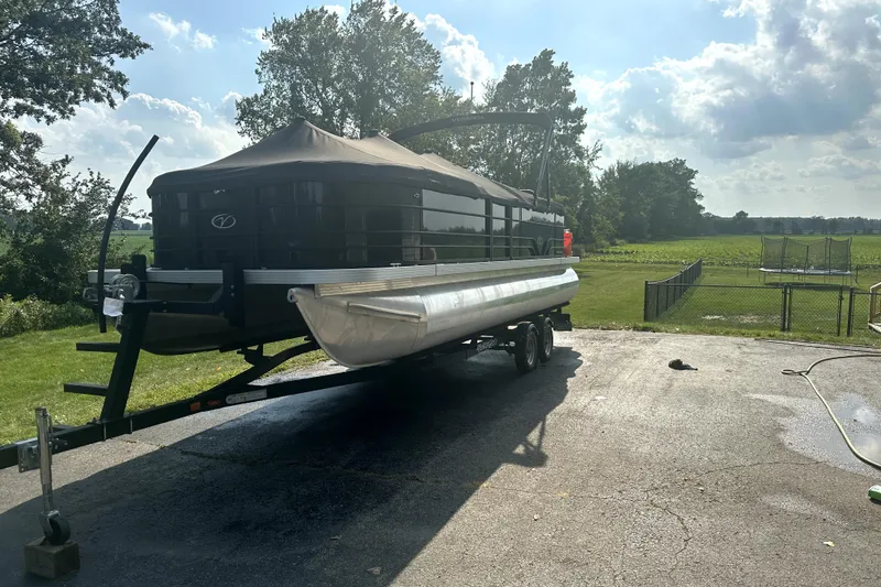 Slide: The Image of 2021 Veranda Vista 22RC pontoon boat on trailer, parked outdoors on a sunny day. - 8