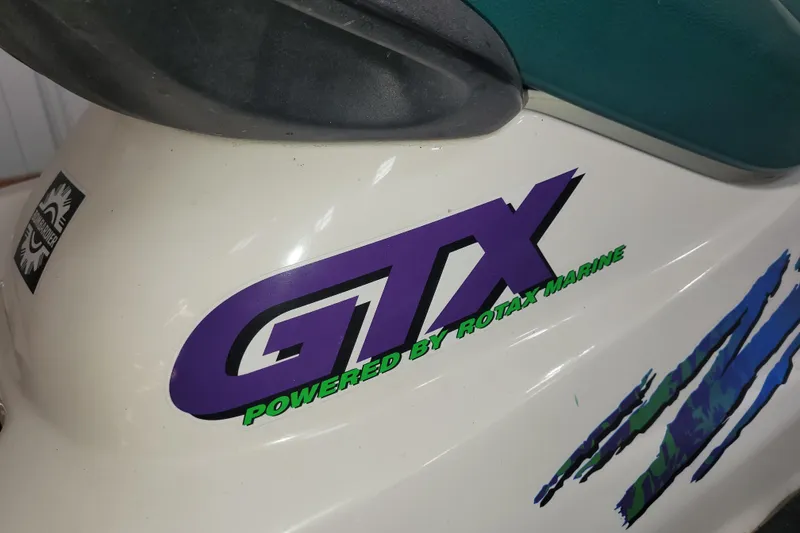 Slide: The Image of 1998 SkiDoo GTX decal, featuring "Powered by Rotax Marine" text on white surface. - 4