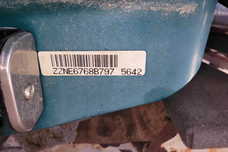 Slide: The Image of 1998 SkiDoo GTX with visible barcode and serial number on blue surface. - 6