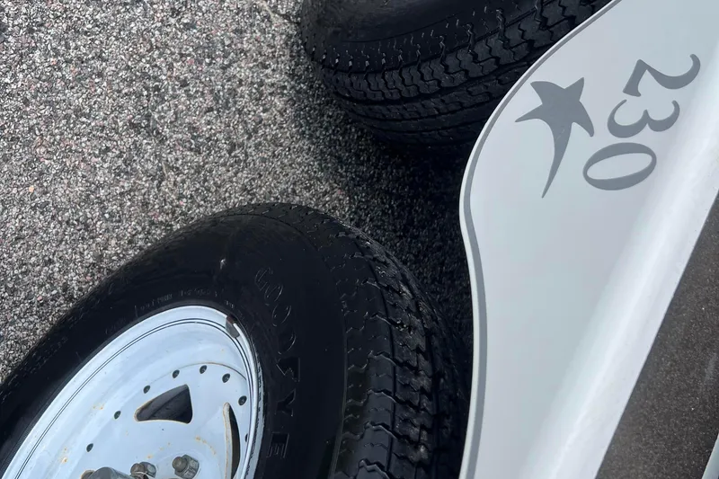 Slide: The Image of Close-up of 2003 Crownline 230 BR trailer tires on asphalt. - 12