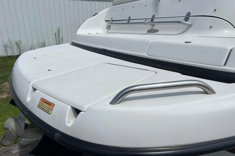 Slide: The Image of 2003 Crownline 230 BR boat stern with swim platform and stainless steel railings. - 16