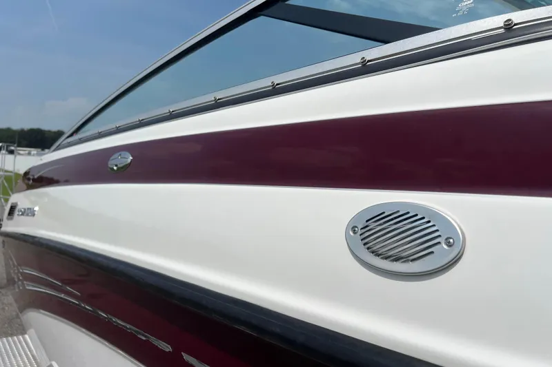 Slide: The Image of 2003 Crownline 230 BR boat with maroon and white exterior detailing. - 30