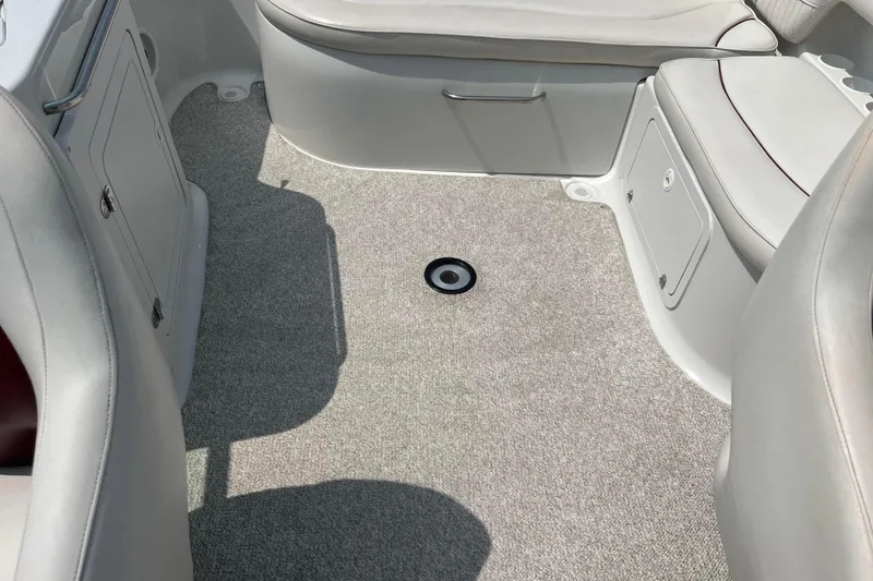 Slide: The Image of 2003 Crownline 230 BR boat interior with gray carpet and white seating. - 39